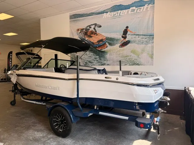 Slide: The Image of A MasterCraft ProStar 2026 boat on a trailer in a showroom. - 3