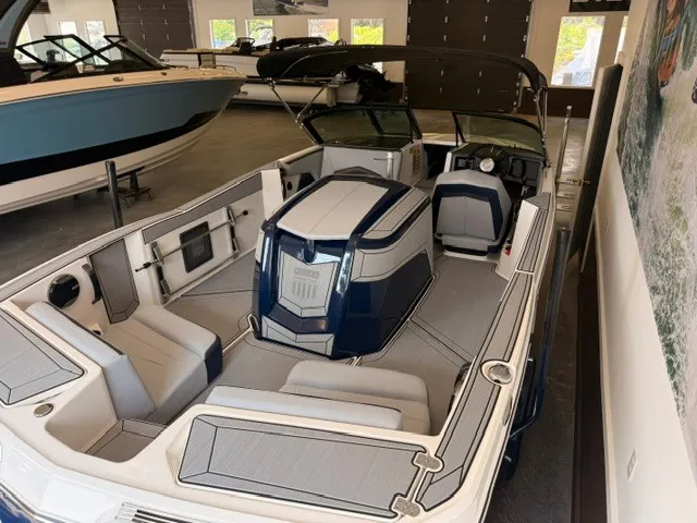 Slide: The Image of The image shows a modern 2026 MasterCraft ProStar boat in a showroom setting. - 12