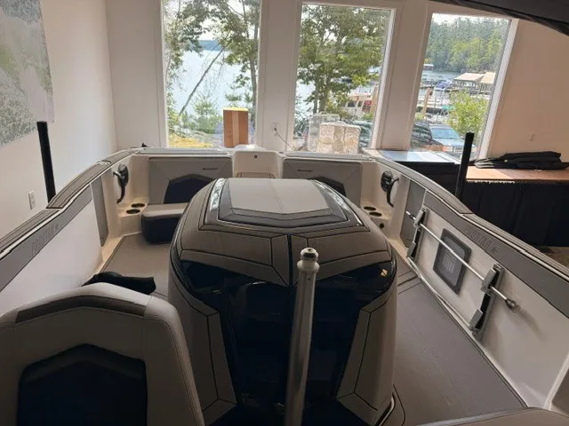 Slide: The Image of Interior of a 2026 MasterCraft ProStar with sleek seating and large windows overlooking a lake. - 11