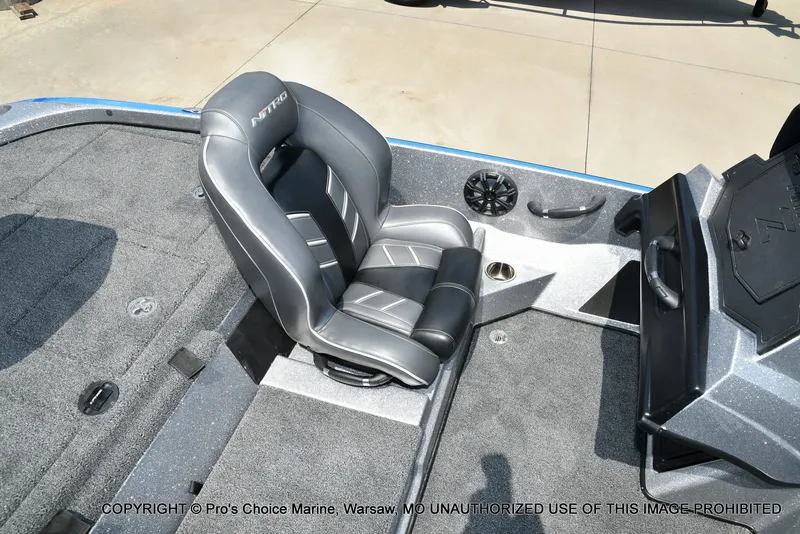 Slide: The Image of The interior of a 2021 Nitro Z21 Pro featuring a cushioned seat and gray carpeted flooring. - 49