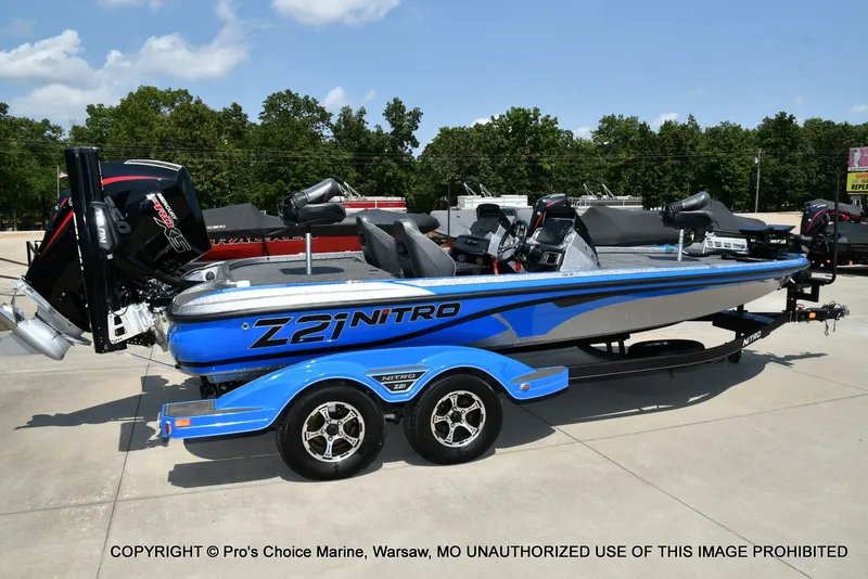 Slide: The Image of A blue 2021 Nitro Z21 Pro boat on a trailer in a parking lot. - 10