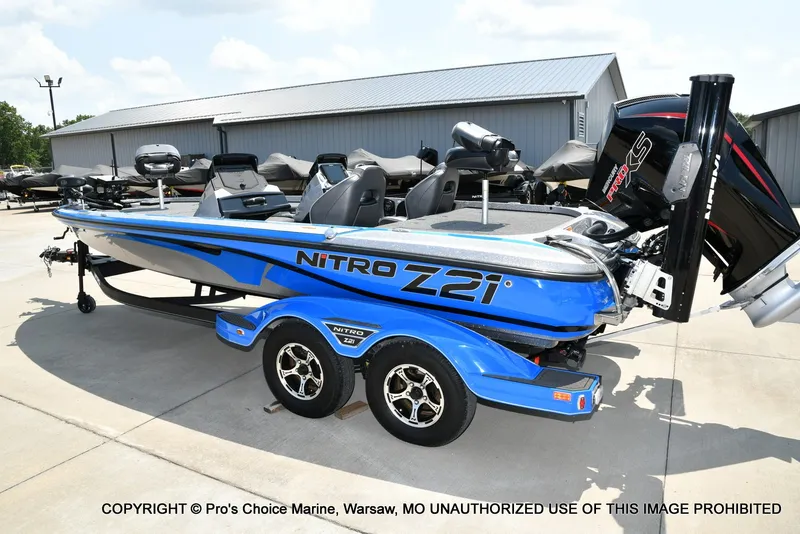 Slide: The Image of A blue 2021 Nitro Z21 Pro boat on a trailer in an outdoor setting. - 26