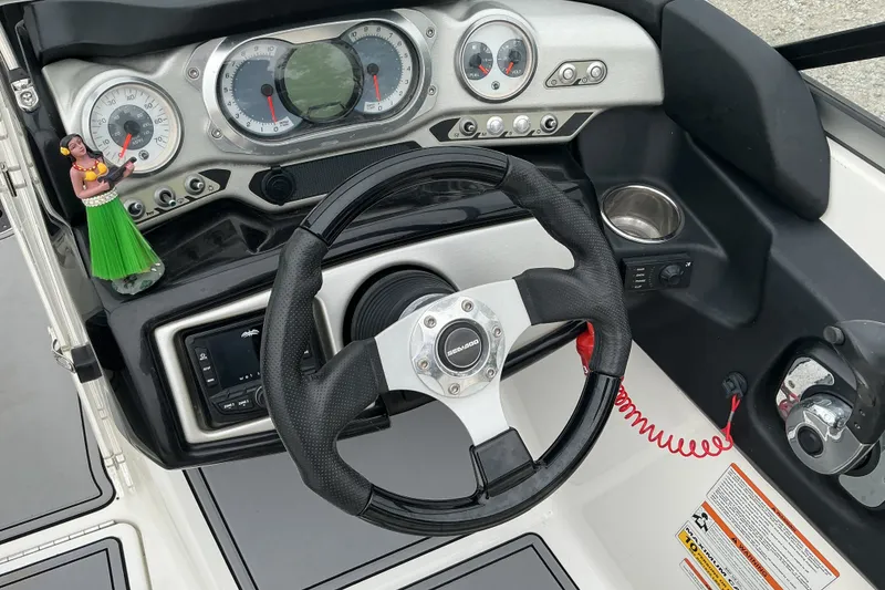Slide: The Image of The image shows the dashboard of a Sea-Doo sport boat with a steering wheel and instruments. - 10