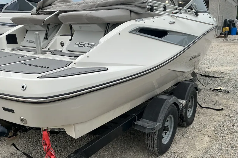 Slide: The Image of A 2010 Sea-Doo Sport Boat 210 Challenger SE on a trailer, featuring gray upholstery and sleek design. - 19
