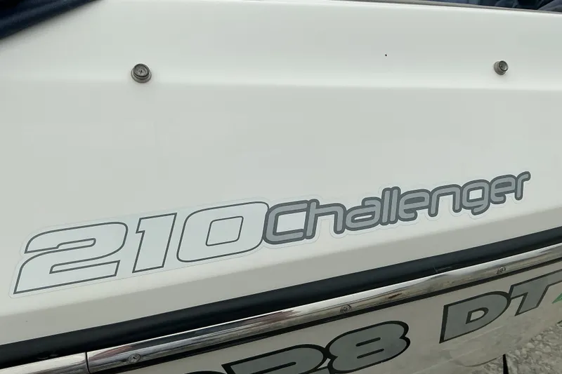 Slide: The Image of Close-up of the "210 Challenger" lettering on a white boat. - 3