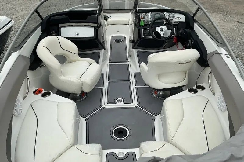 Slide: The Image of The image shows the cockpit of a Sea-Doo sport boat with white seats and gray flooring. - 6