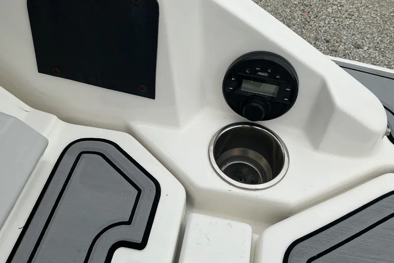 Slide: The Image of Close-up of a boat console area with a cup holder and a control unit. - 18
