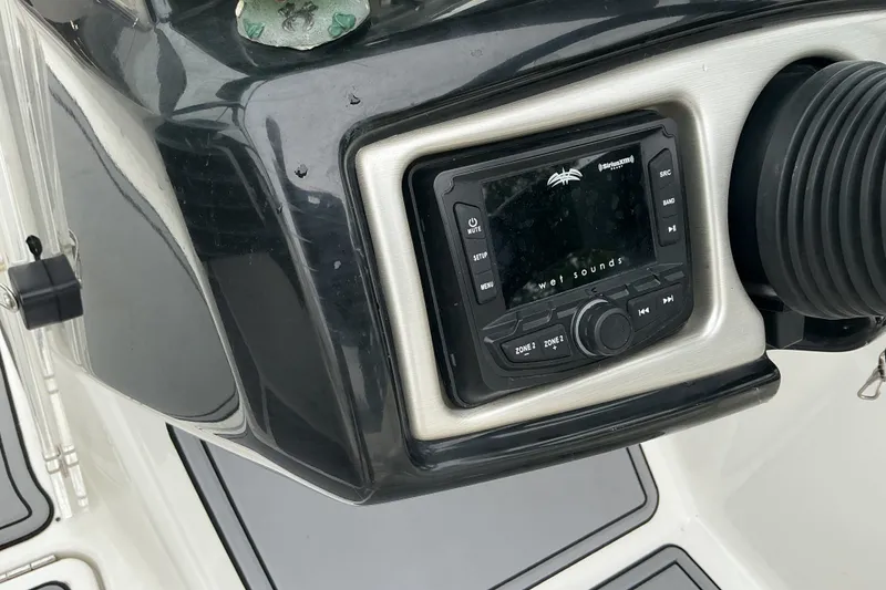 Slide: The Image of The image shows a helm console with a built-in audio system on a Sea-Doo sport boat. - 12