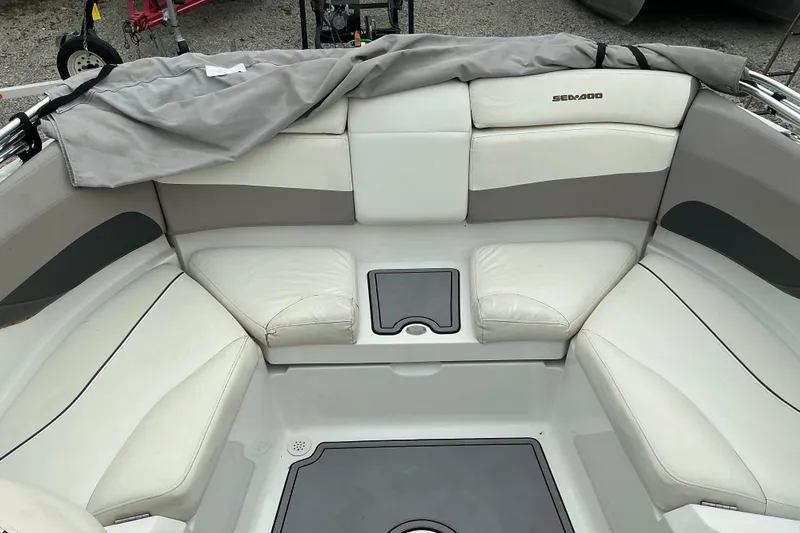 Slide: The Image of The image shows the seating area of a Sea-Doo sport boat with white and gray upholstery. - 8