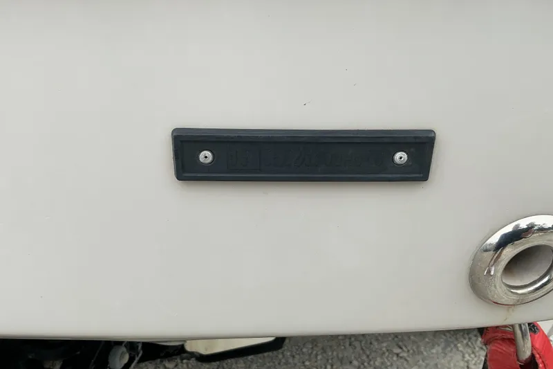 Slide: The Image of Close-up of a boat hull with a black plaque and a metal ring. - 15