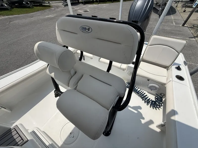 Slide: The Image of The image shows the cockpit of a 2024 Sea Hunt BX Series 22-LOADED OUT boat with beige seats. - 10