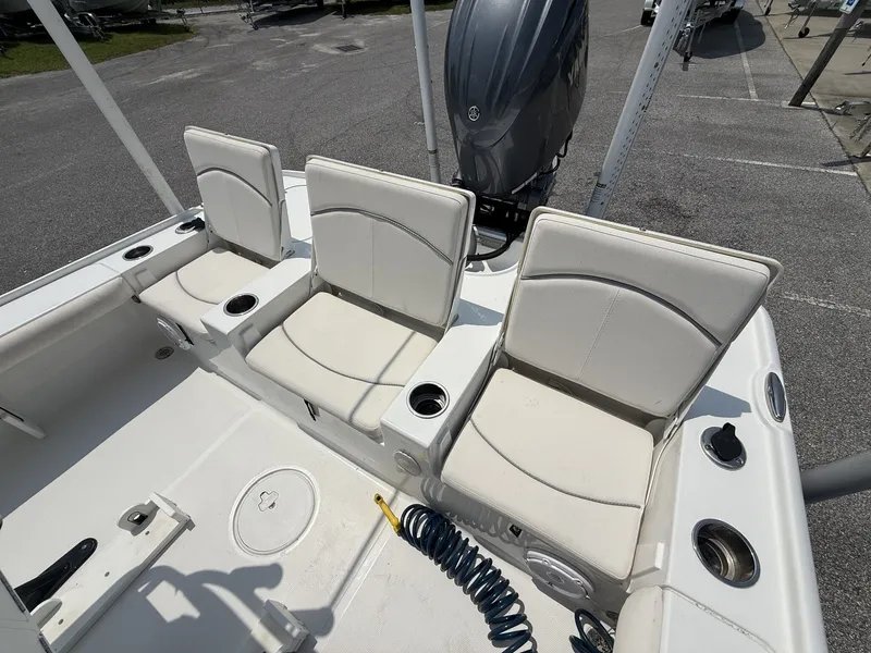 Slide: The Image of The image shows three white seats on a boat, with cup holders and an engine in the background. - 13