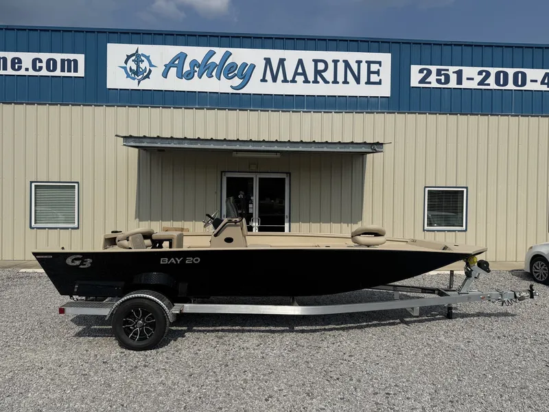 The Image of A 2027 G3 Bay 20 boat on a trailer in front of a building labeled "Ashley Marine." - 1