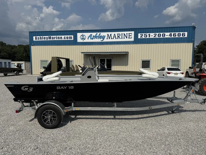 The Image of A G3 Bay 18 BAY-F90 SHO boat on a trailer in front of a building labeled "Ashley Marine." - 1