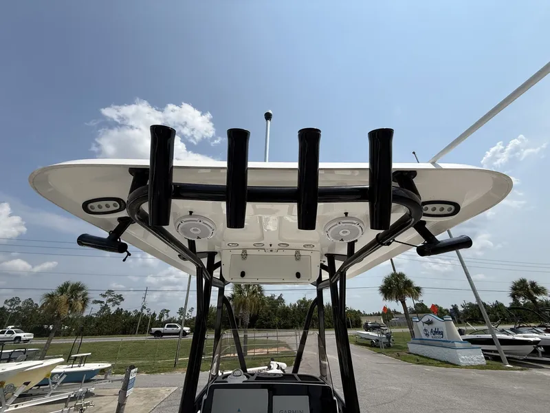 Slide: The Image of The image shows the T-top of a Sea Hunt BX Series 22-LOADED OUT boat with rod holders. - 12