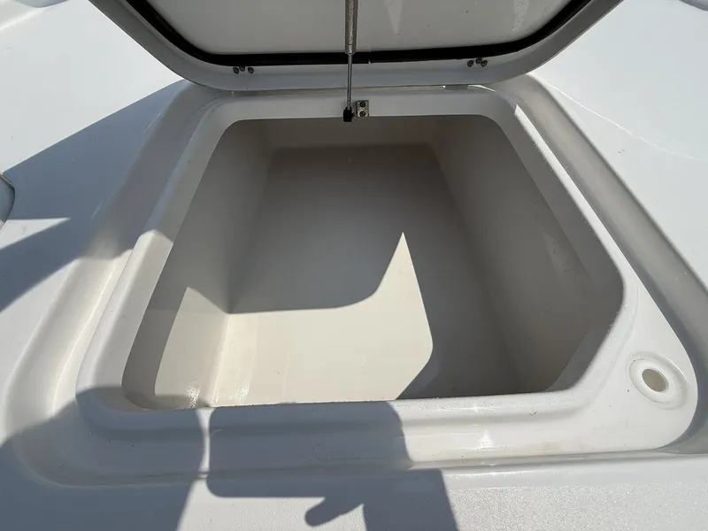 Slide: The Image of Open storage compartment on a boat with a white interior and lid. - 8
