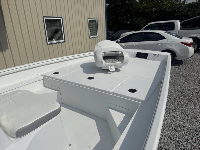 Slide: The Image of A white boat with seating and storage on a trailer next to a building. - 5