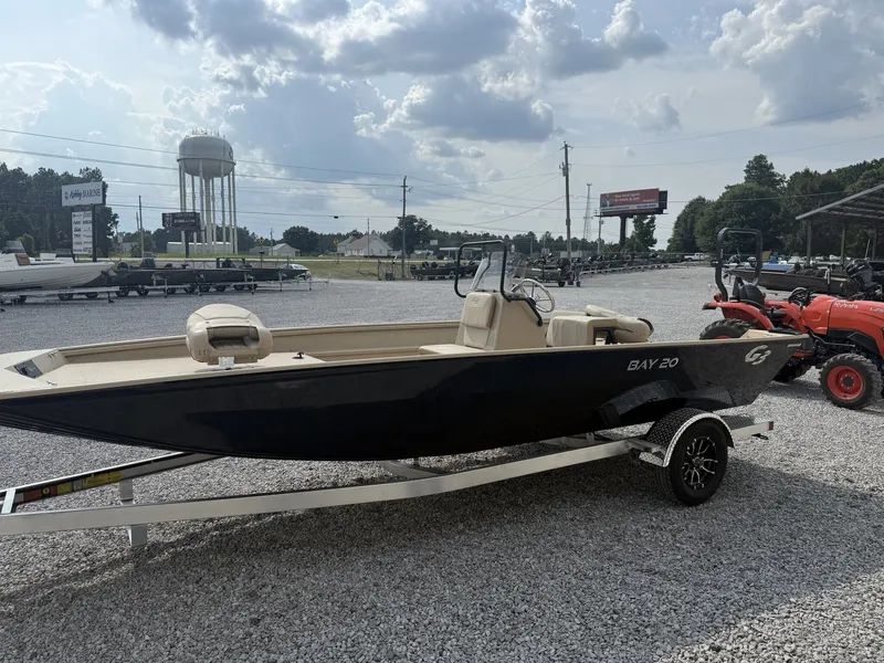 Slide: The Image of A black G3 Bay 20 boat from 2027 sits on a trailer in a gravel lot. - 2