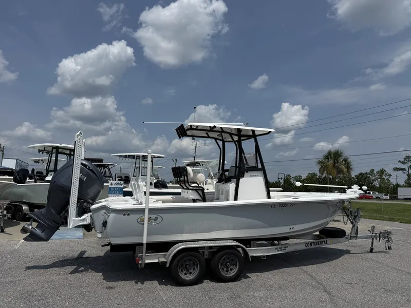Slide: The Image of A 2024 Sea Hunt BX Series 22-LOADED OUT boat on a trailer, featuring an outboard motor. - 2