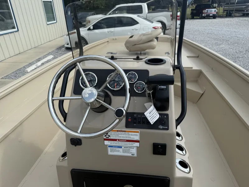 Slide: The Image of The image shows the helm of a 2027 G3 Bay 20 boat with a steering wheel and gauges. - 3