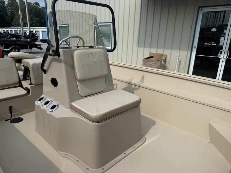 Slide: The Image of The image shows the helm of a G3 Bay 20 boat with a beige seat. - 5
