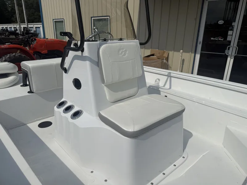 Slide: The Image of The image shows the helm of a G3 Bay 17 boat with white seating and holders. - 4