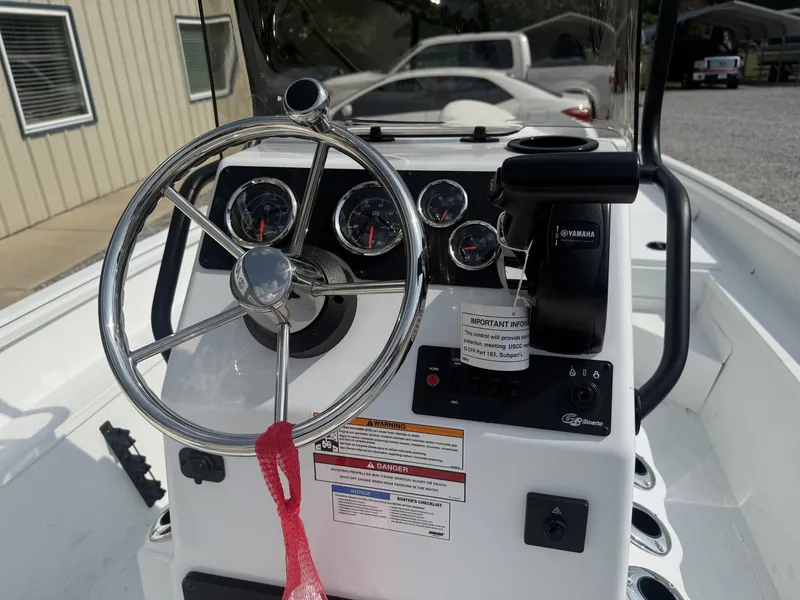 Slide: The Image of The image shows the helm of a G3 Bay 17 boat with multiple gauges and a steering wheel. - 2