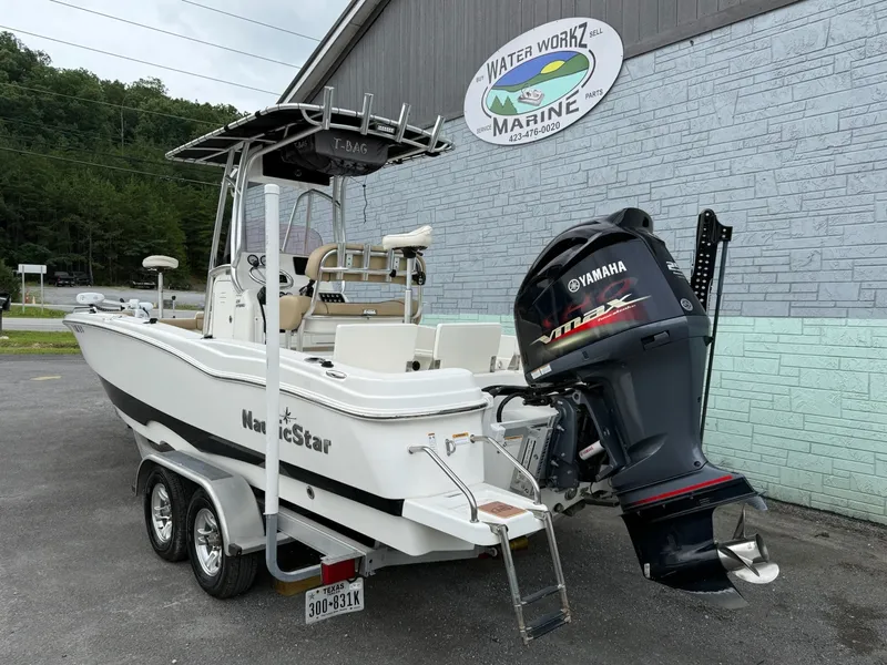 Slide: The Image of A white 2019 NauticStar 231 HYBRD CC boat on a trailer. It features a Yamaha outboard motor. - 4