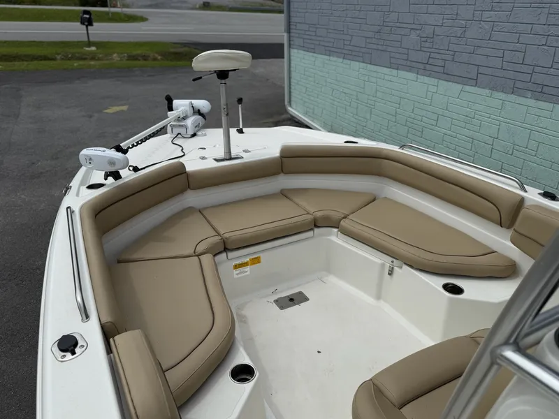 Slide: The Image of The image shows the bow area of a 2019 NauticStar 231 HYBRD CC with beige cushions. - 10