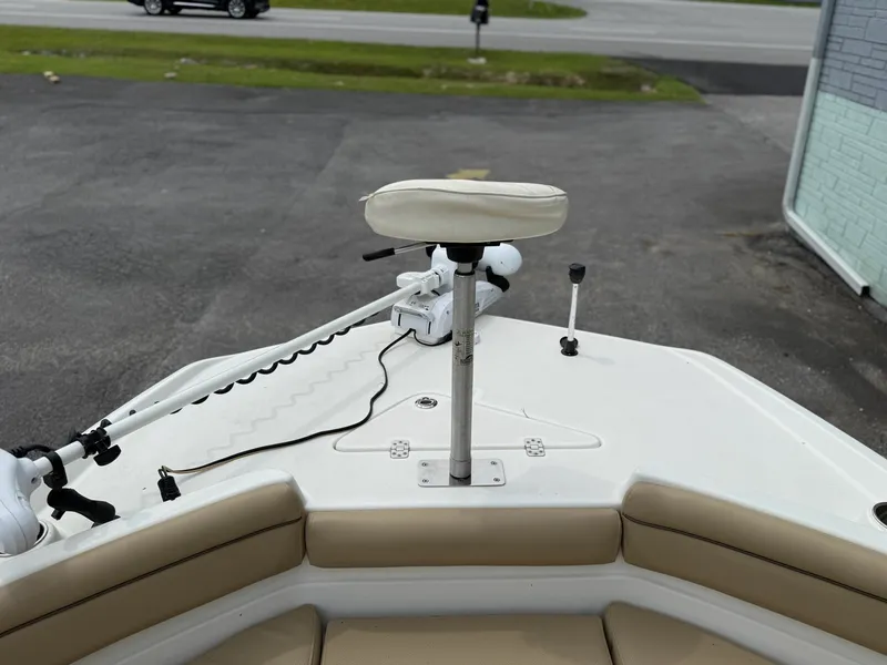 Slide: The Image of The image shows the bow of a NauticStar 231 HYBRD CC boat with a seat and controls. - 11
