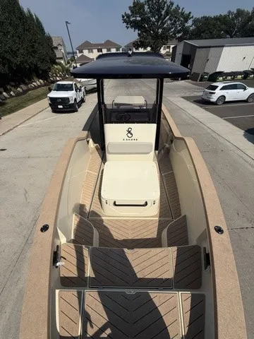 Slide: The Image of A modern electric boat with an open deck and sleek lines, parked in a residential area. - 19