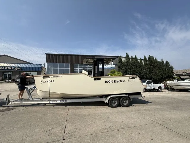 Slide: The Image of An X Shore Eelex 8000 electric boat on a trailer in front of a building. - 9