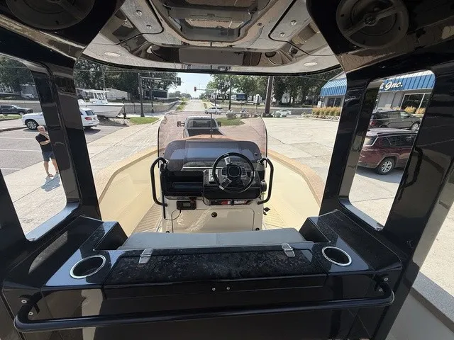 Slide: The Image of The image shows the cockpit of a 2023 X Shore Eelex 8000. It features a modern design with a central helm and large steering wheel. The setting is urban with parked cars. - 17