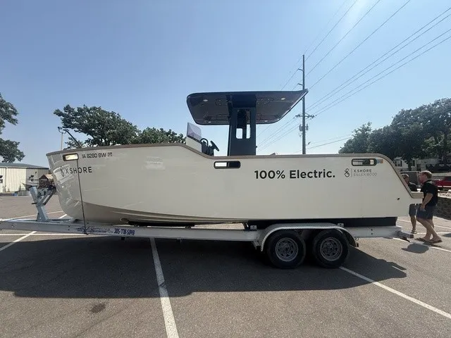 Slide: The Image of A 2023 X Shore Eelex 8000 boat on a trailer, labeled "100% Electric." - 10