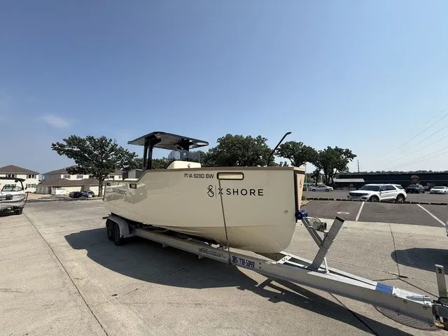 Slide: The Image of A 2023 X Shore Eelex 8000 boat on a trailer in a parking lot. - 4