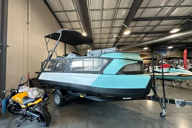 The Image of A 2026 Sea-Doo boat in a warehouse. It features a modern design and is mounted on a trailer. - 1