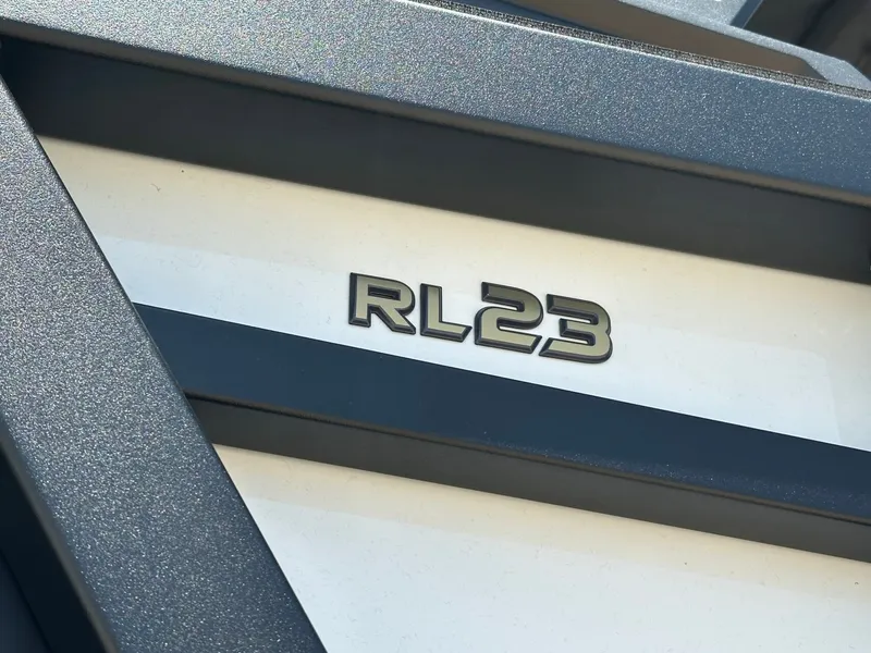 Slide: The Image of Close-up of the RL23 logo on a boat, surrounded by gray and white surfaces. - 11