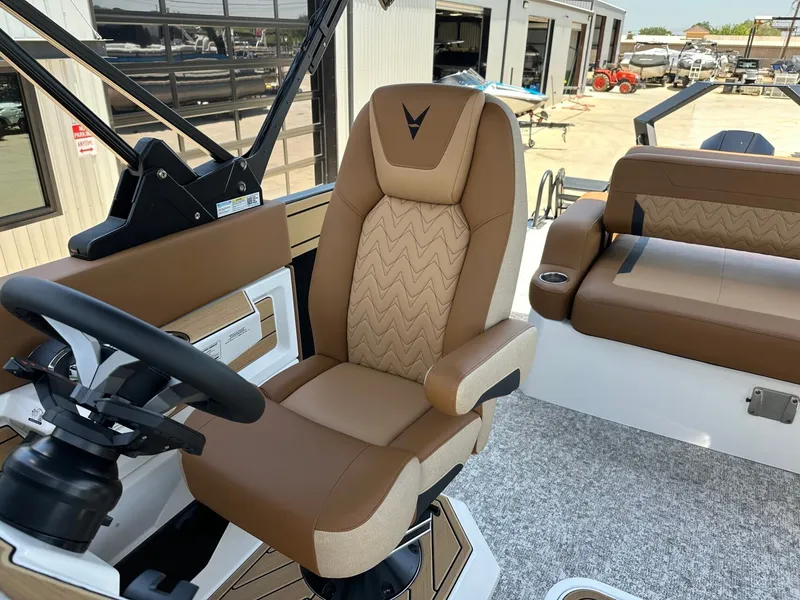 Slide: The Image of Interior of a 2027 Revel RL23 with brown leather seats and a modern helm station. - 27