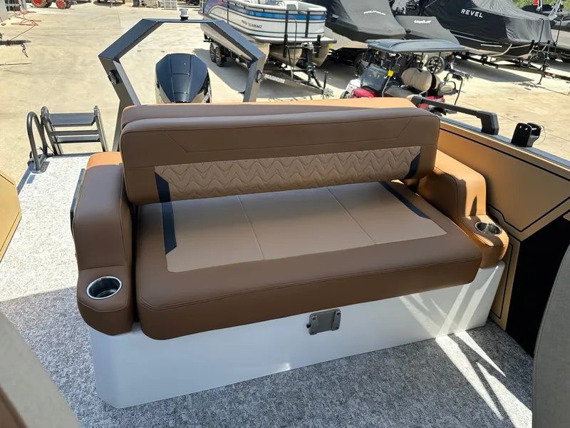 Slide: The Image of The image shows a brown bench seat on a boat with cup holders and a motor in the background. - 32