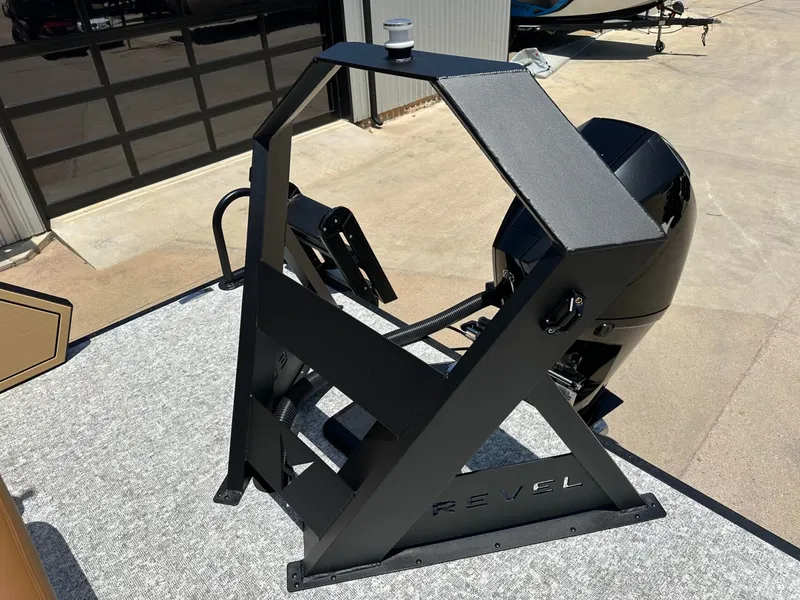 Slide: The Image of A modern black helm console on a boat, featuring the "Revel" logo. It sits on a concrete floor. - 40