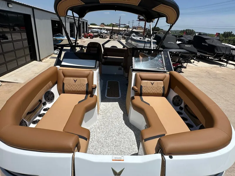 Slide: The Image of The image shows a modern boat with brown leather seating and an open deck, docked at a marina. - 12