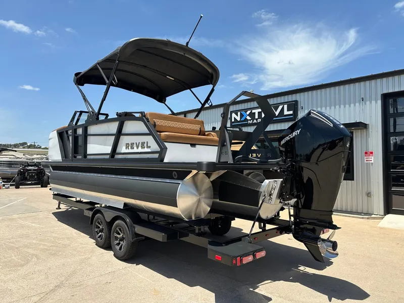 Slide: The Image of The image shows a modern pontoon boat on a trailer. It features a black canopy and a powerful outboard motor. - 3