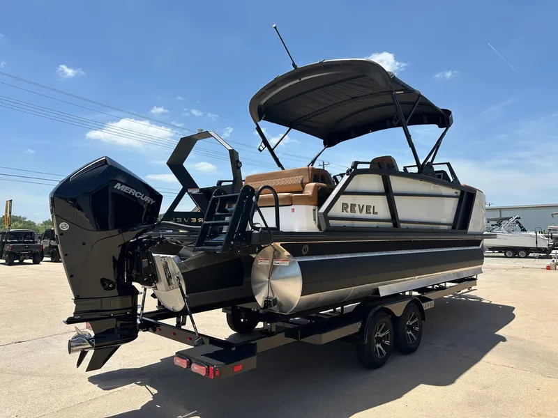Slide: The Image of The image shows a modern pontoon boat on a trailer. It features a black outboard motor and a sunshade. - 5