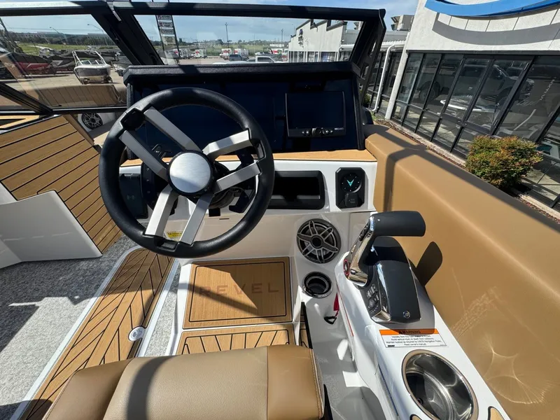 Slide: The Image of Helm of a 2027 Revel RL23 boat with modern steering wheel and controls. - 29