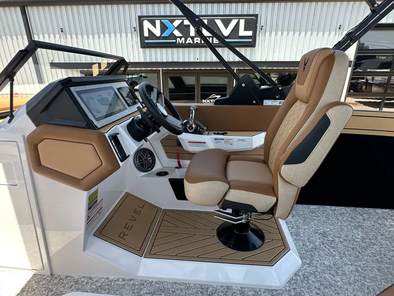 Slide: The Image of The image shows the cockpit of a 2027 Revel RL23 boat with a modern helm station. - 28