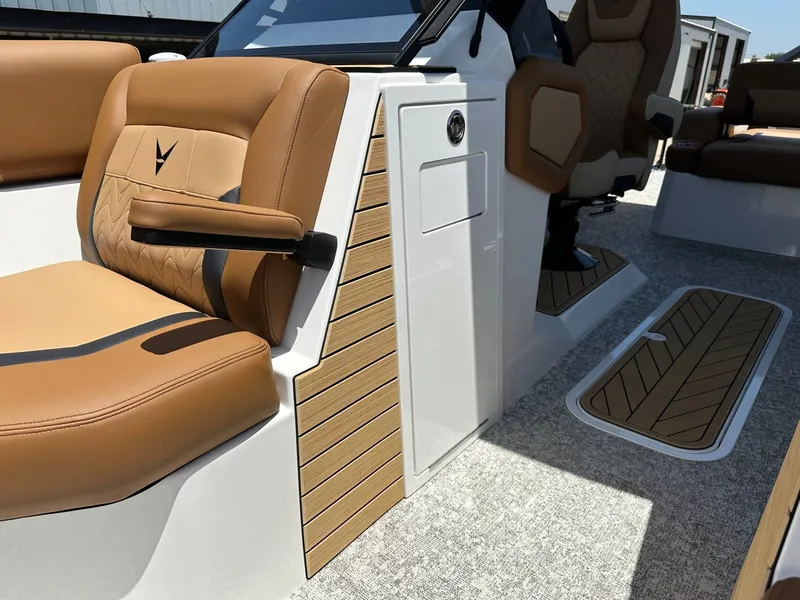Slide: The Image of The image shows the interior of a 2027 Revel RL23 boat with sleek brown seating. - 18