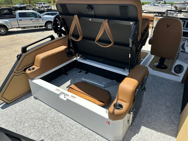 Slide: The Image of The image shows the interior of a 2027 Revel RL23 boat with foldable seating. - 38