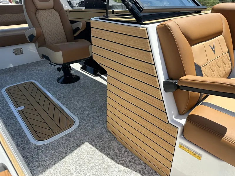 Slide: The Image of The image shows the interior of a Revel RL23 boat with brown leather seats and wood accents. - 20