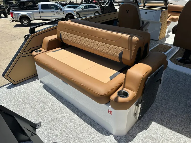 Slide: The Image of The image shows a luxurious boat seat with brown leather and cup holders. - 33