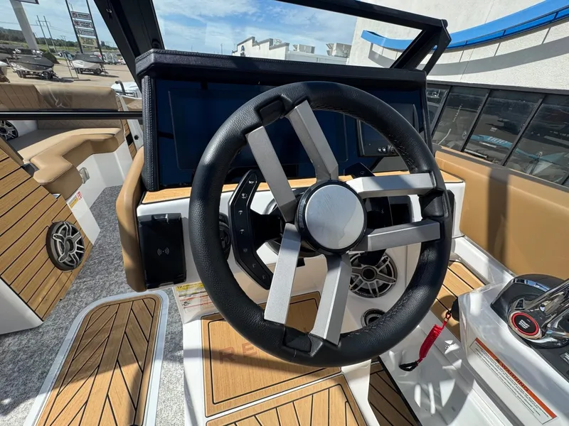 Slide: The Image of The image shows the cockpit of a 2027 Revel RL23 boat with a modern steering wheel. - 30